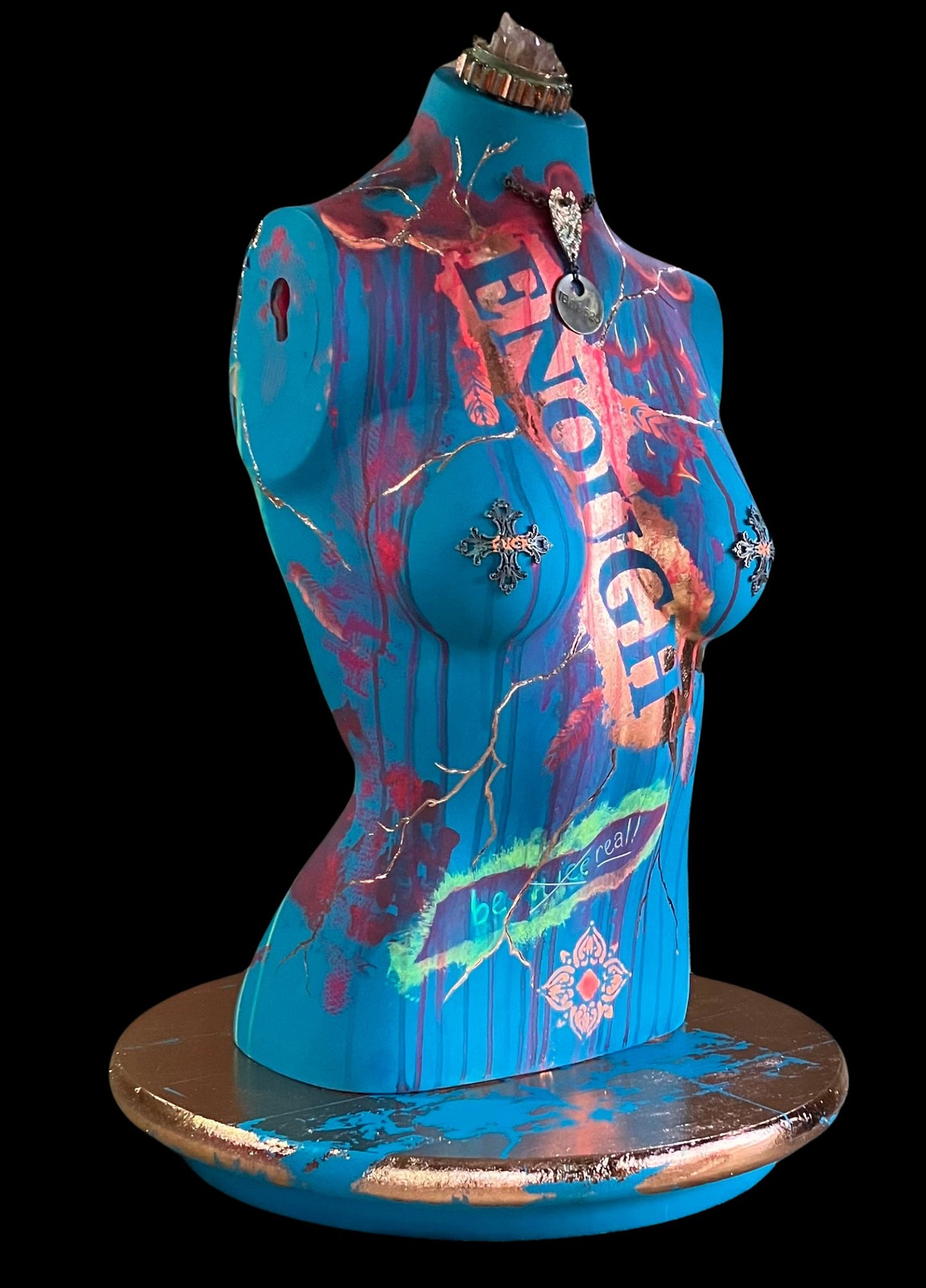 Right side and front view of mixed media mannequin sculpture titled "Break Free", featuring bold turquoise body, rose gold accents, the word ENOUGH, and a turning base by J Elise Art.
