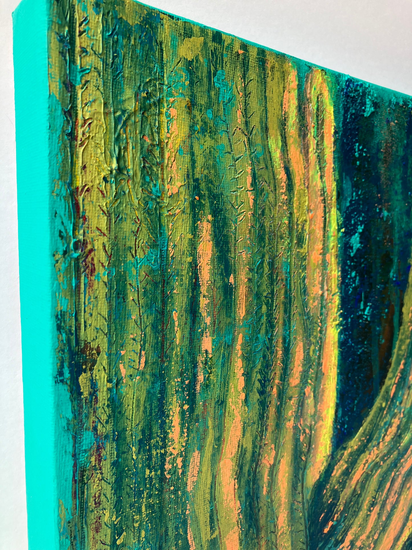 Close up of textured abstract painting in vibrant peach, gold, and turquoise tones, resembling soft sunlight on a majestic saguaro cactus. Artwork by J. Elise.