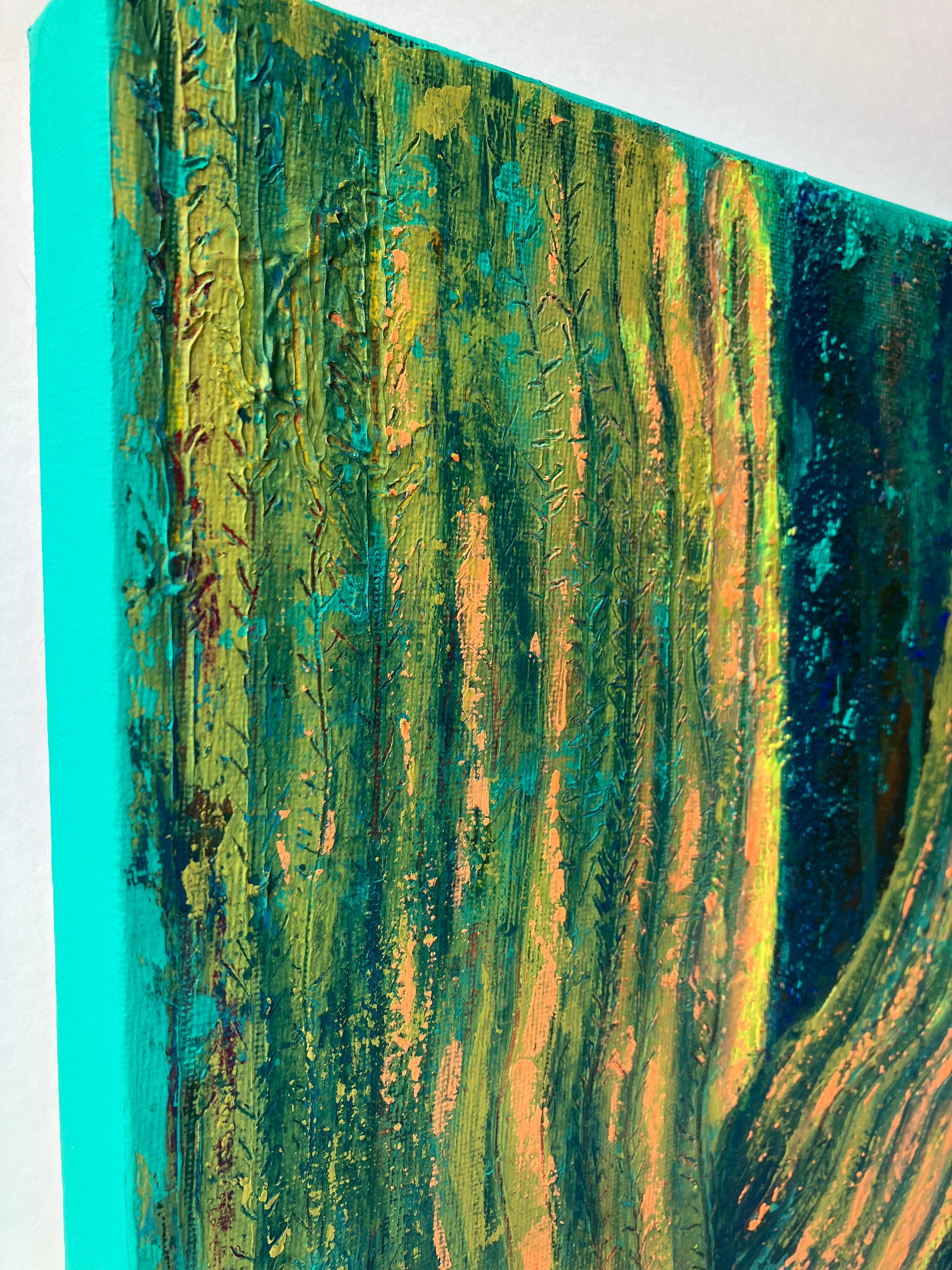 Close up of textured abstract painting in vibrant peach, gold, and turquoise tones, resembling soft sunlight on a majestic saguaro cactus. Artwork by J. Elise.