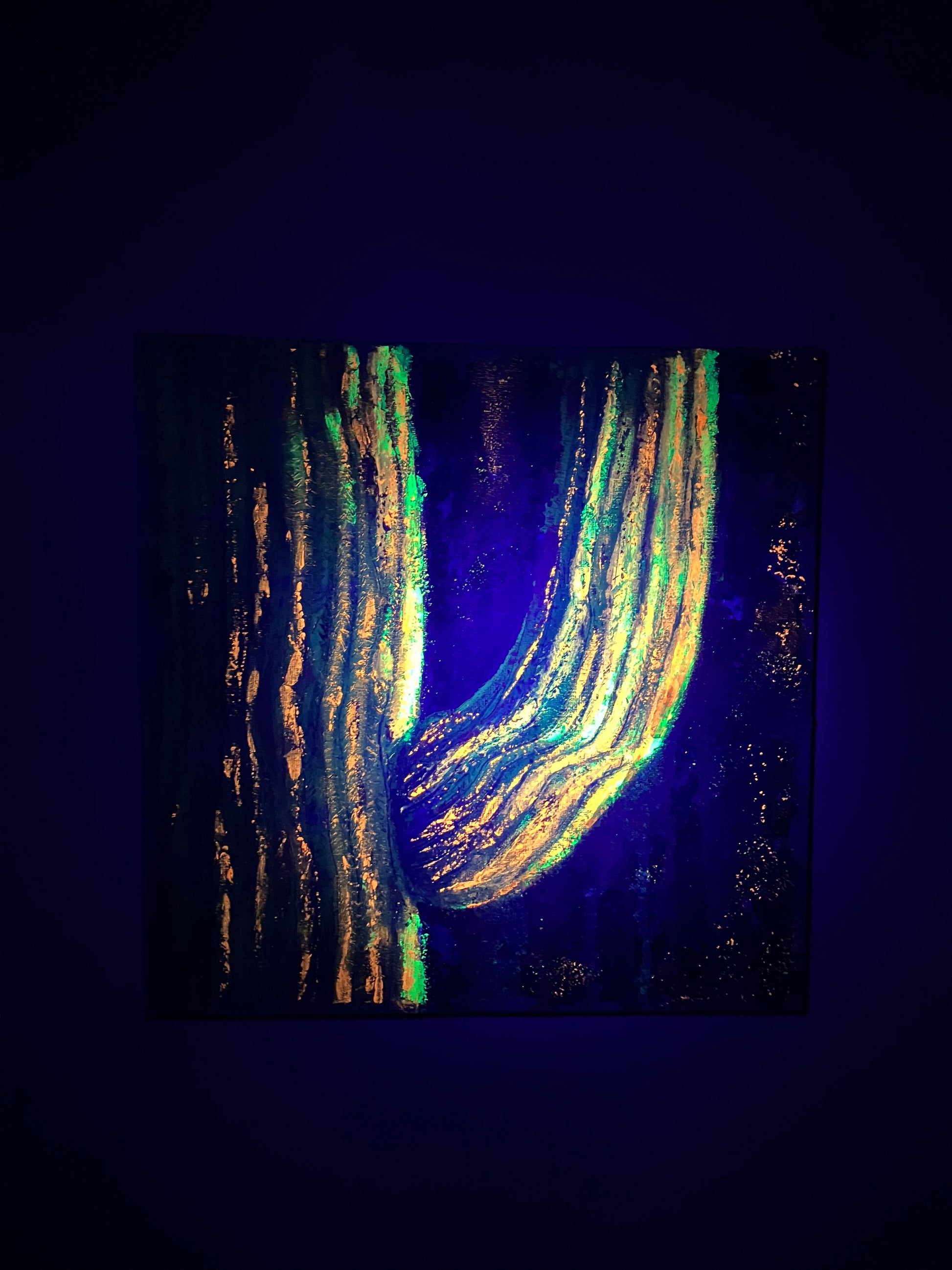 Textured abstract painting in vibrant peach, gold, and turquoise tones, resembling soft sunlight on a majestic saguaro cactus shown fluorescing under a blacklight. Artwork by J. Elise.