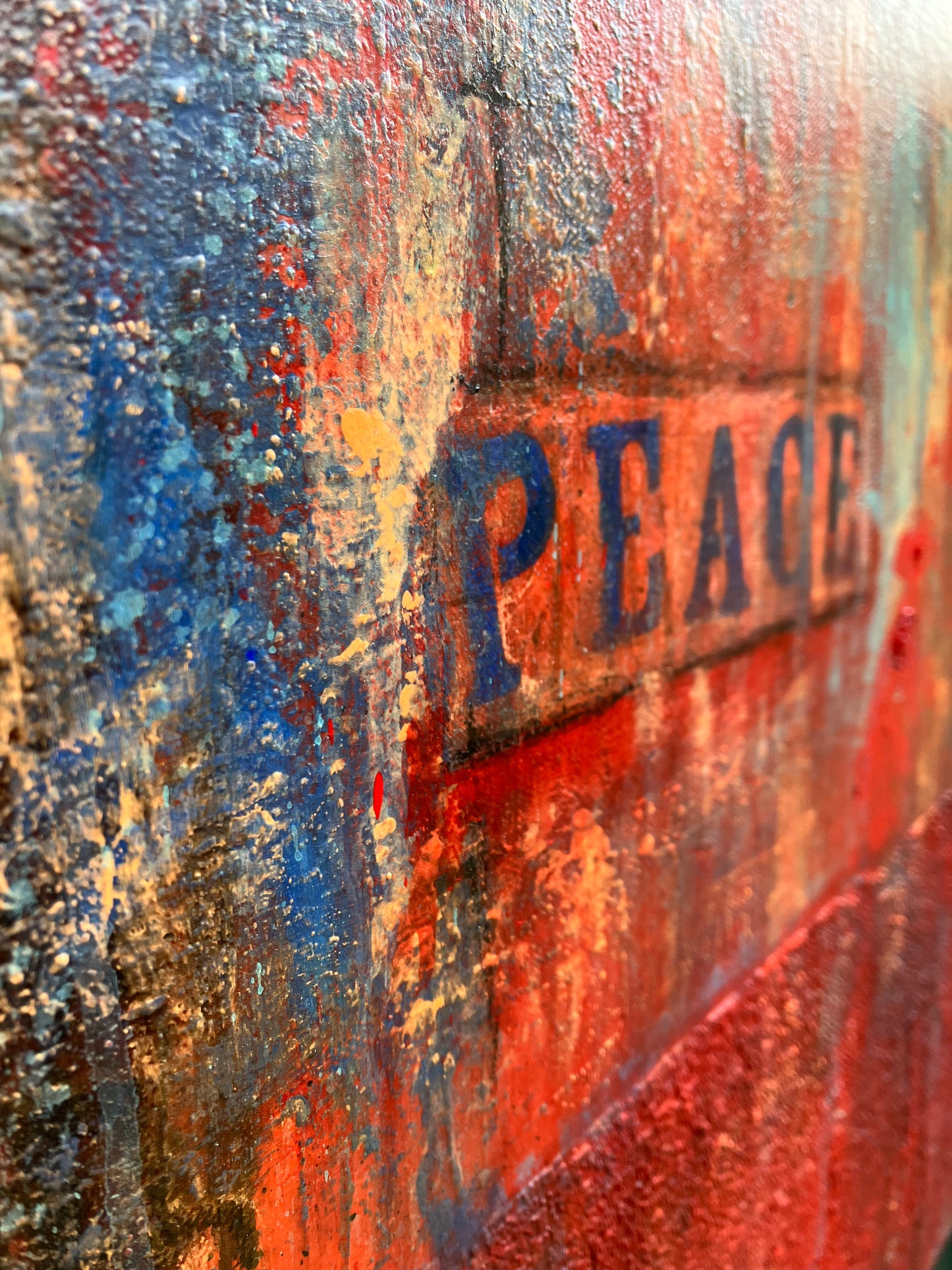 Close up of the word "PEACE" surrounded by rich texture and bold color transitions create emotional depth.